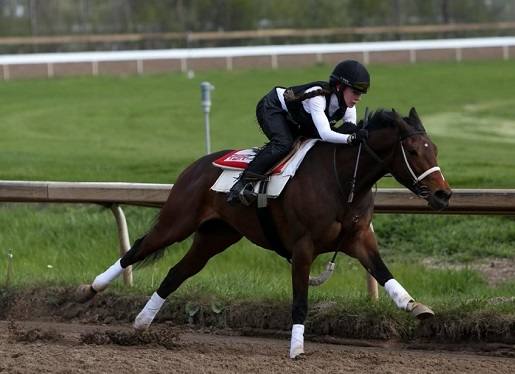 Katie Larsen breezing a horse at the Fort